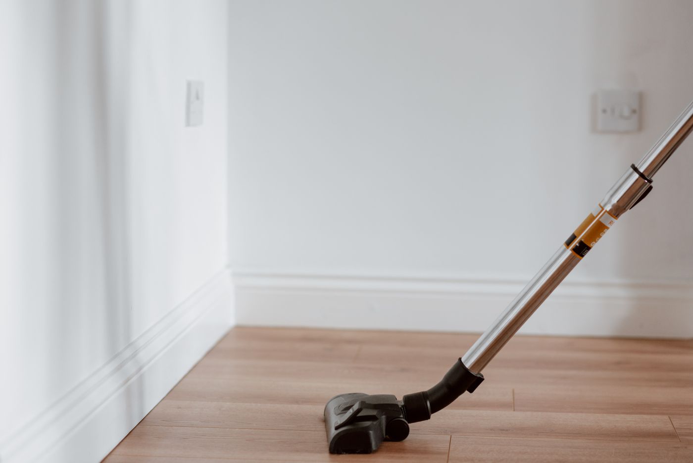 Vacuuming an empty rental suite during an occupancy clean